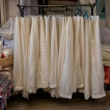 A collection of elegant white fabrics and lace crafts on display in a boutique shop in İzmir, Türkiye.